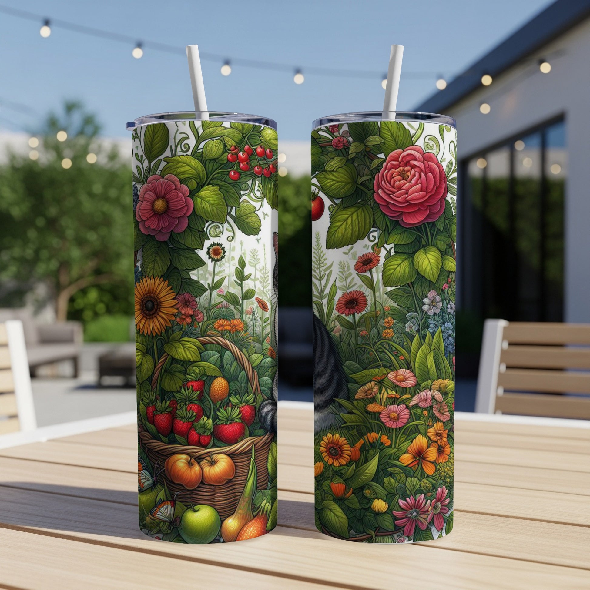 Two tumblers with floral and fruit designs on an outdoor table.