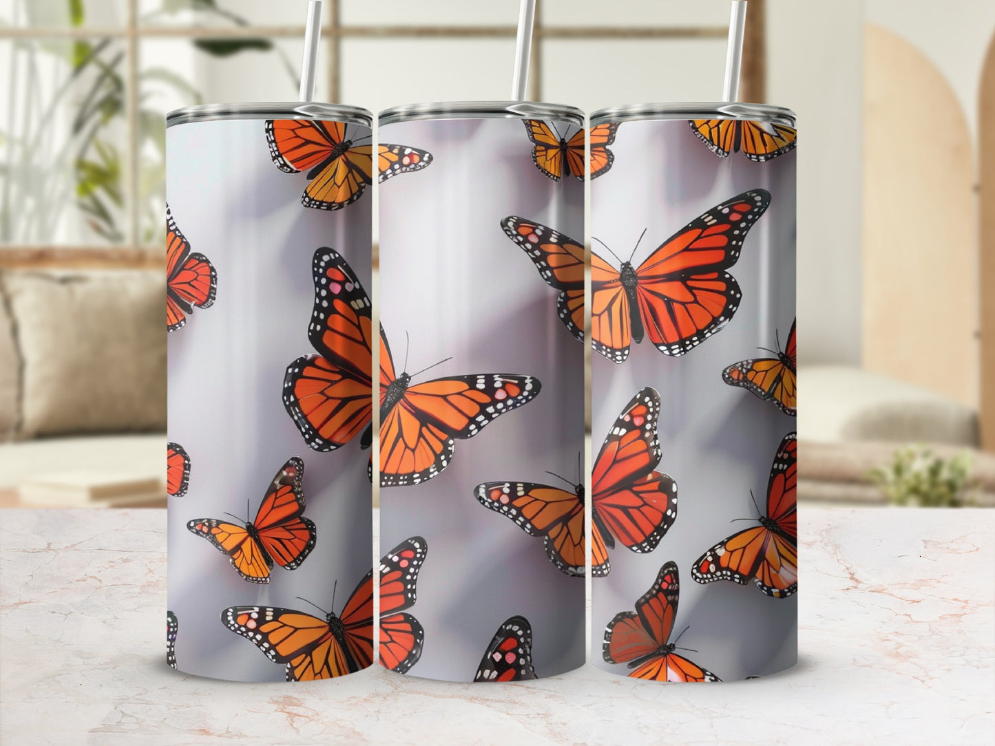 Tumbler with multiple monarch butterflies on a light background.