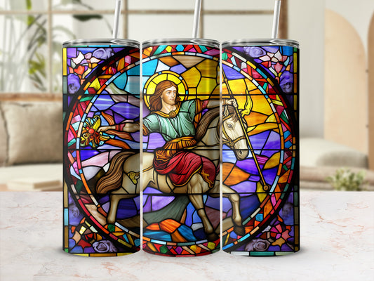 Stained glass tumbler featuring a saint on horseback against a colorful geometric background.