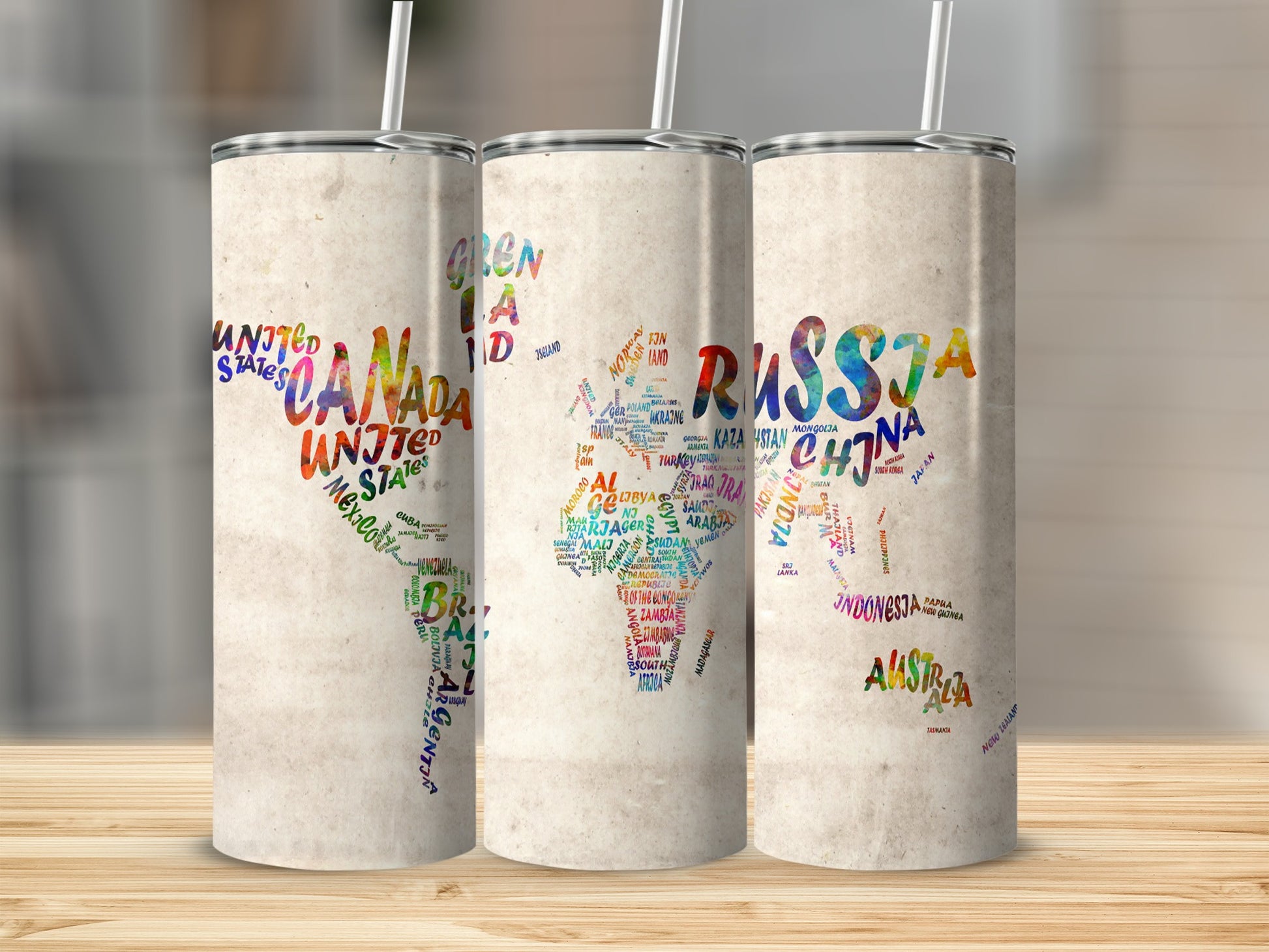 Three tumblers with world maps made of colorful country names on faded parchment.