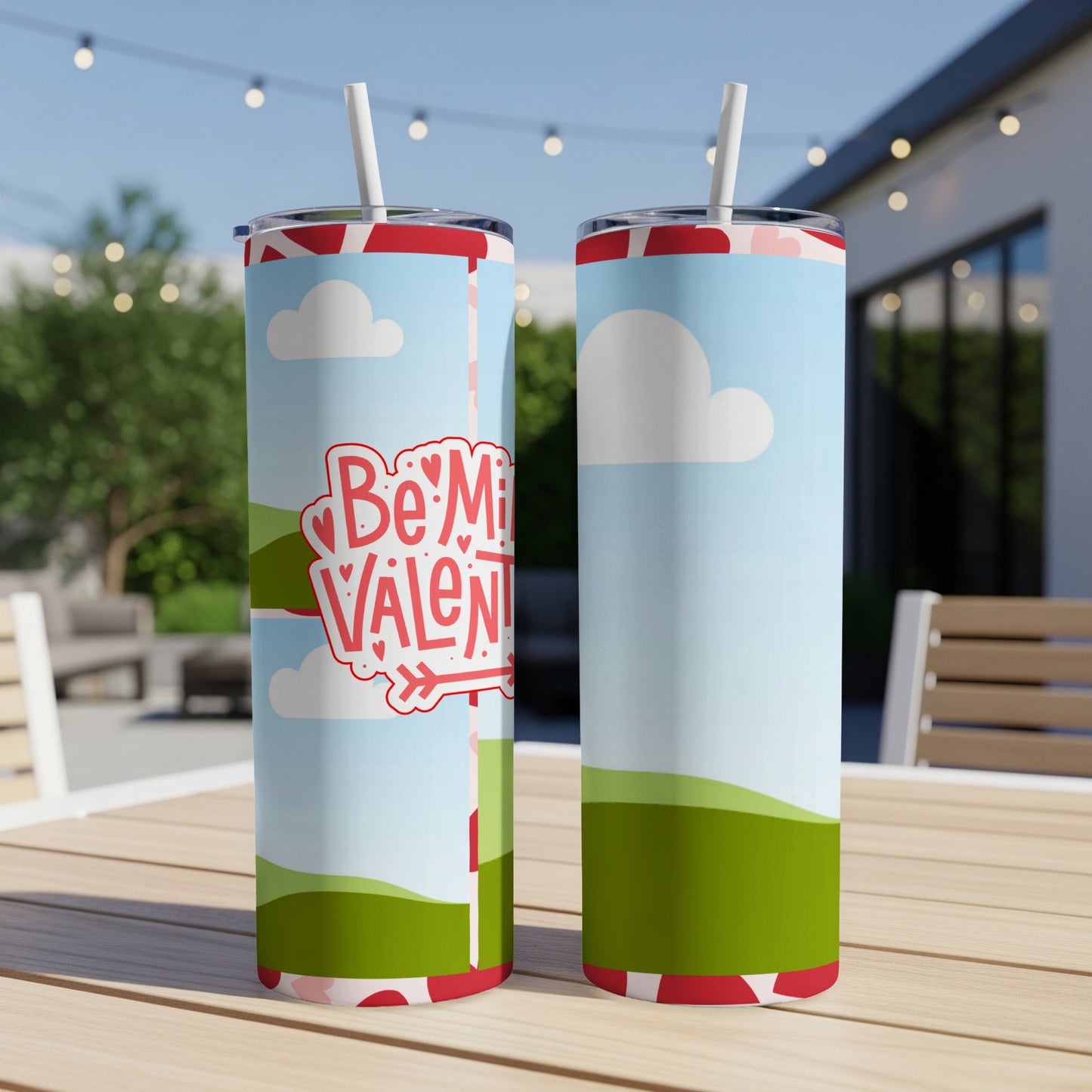 Two tumblers with a "Be My Valentine" design featuring clouds and rolling green hills.