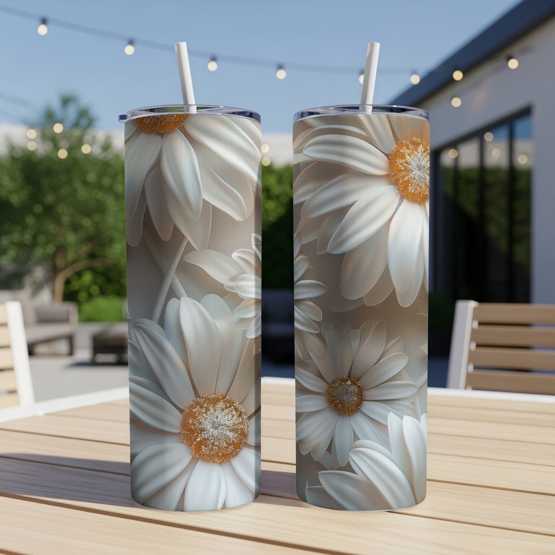 Two tall tumblers with white daisy floral pattern on a wooden table.