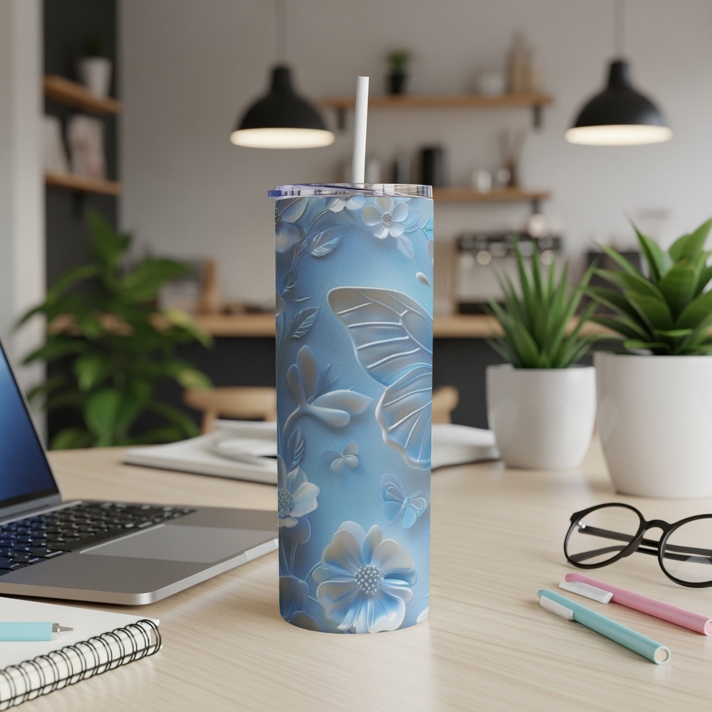 Light blue tumbler with butterfly and floral embossed design.