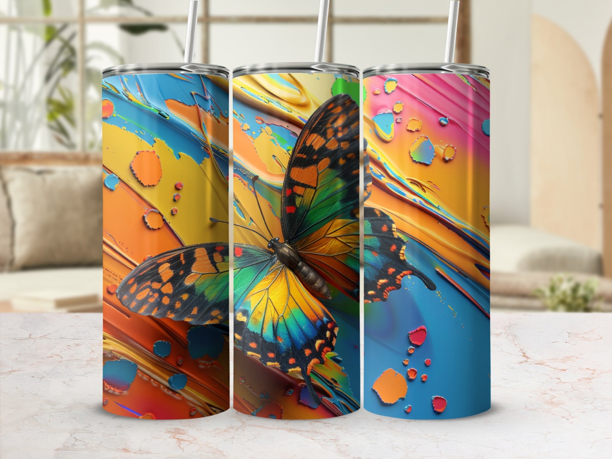 Tumbler with butterfly and colorful abstract paint splatter design.