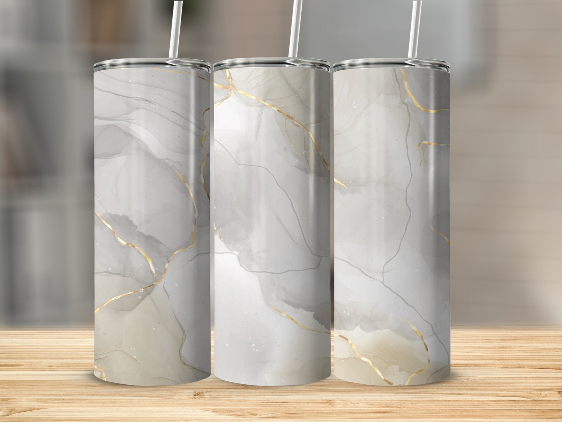 Three tumblers with abstract marble and gold veining patterns.