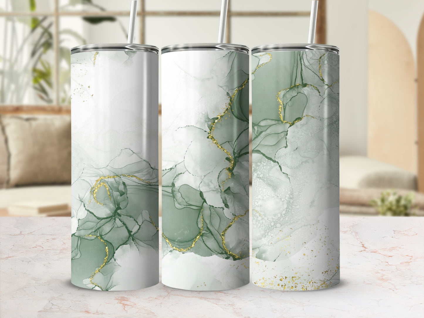 Three tall, slender tumblers with abstract green and gold marbled designs.