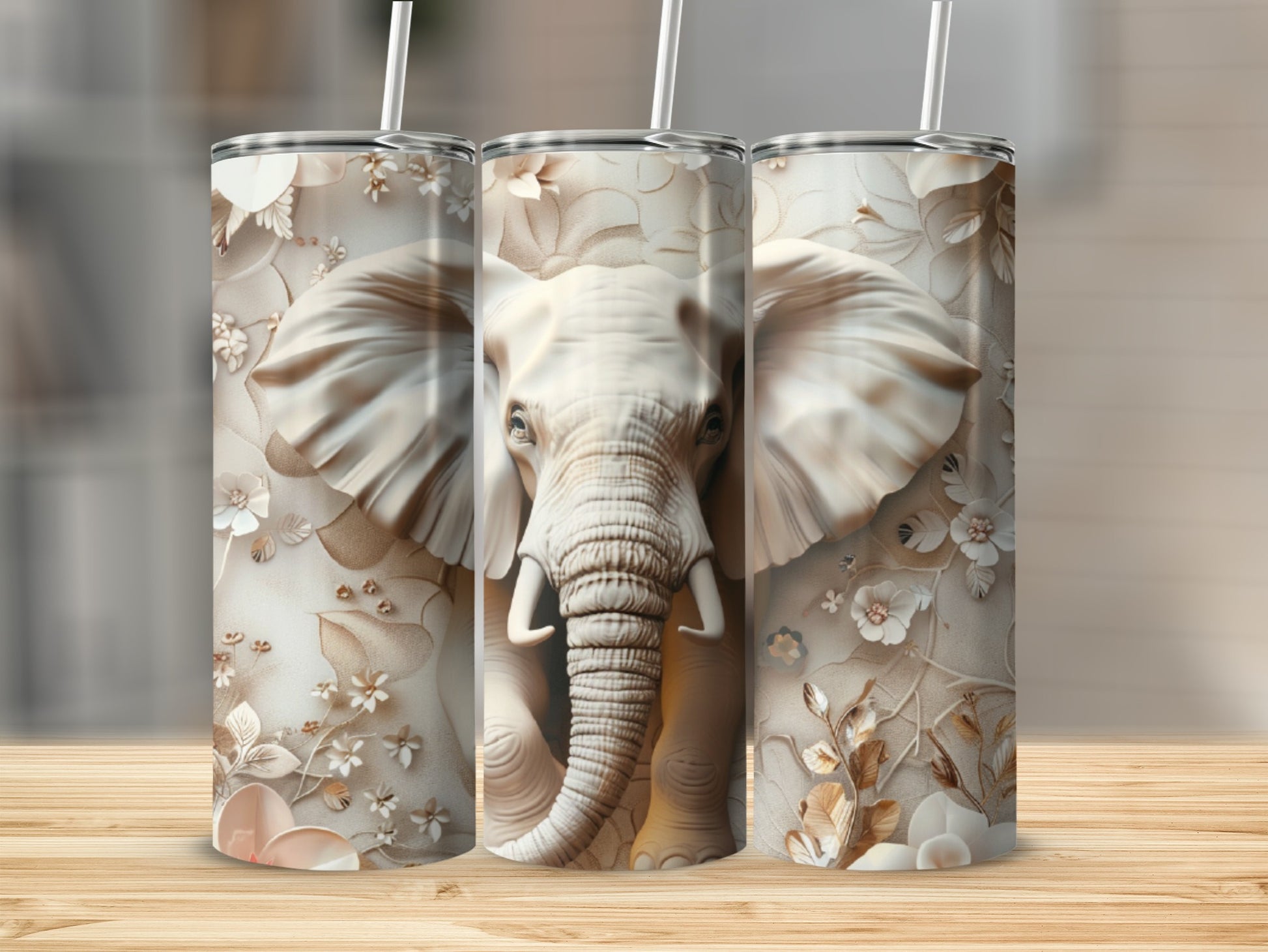 Three tumblers with a close-up of an elephant's face and floral designs.
