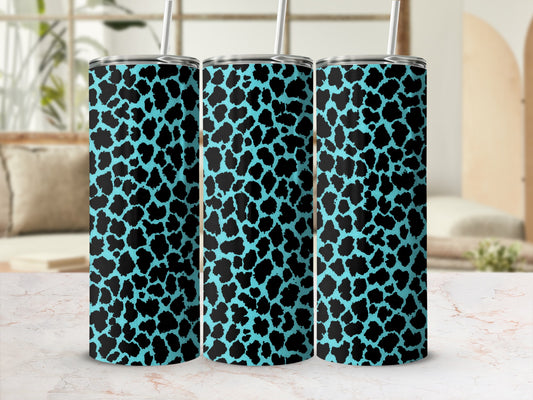 Three tall tumblers with black leopard print on a bright blue background.