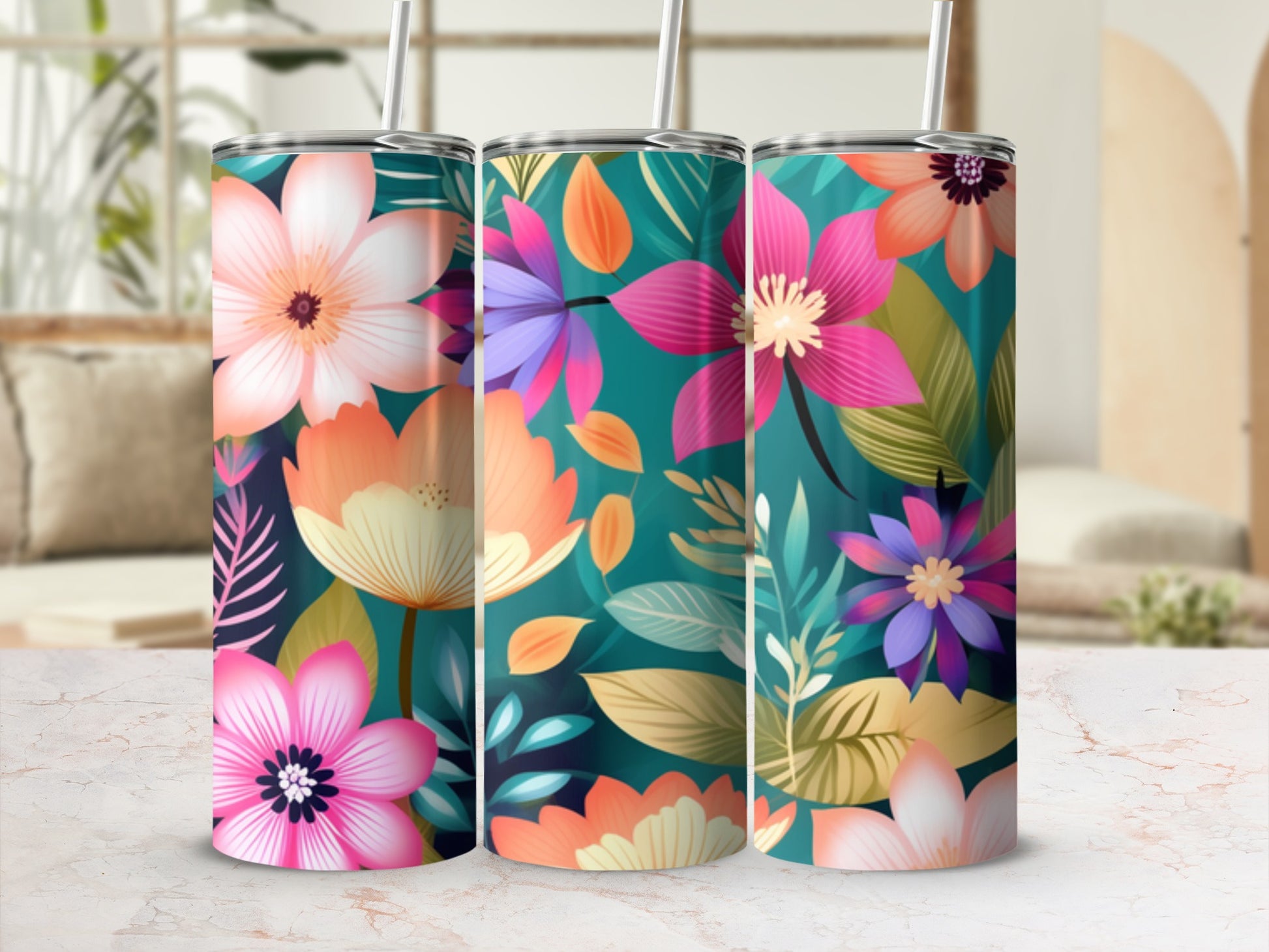 Three tall tumblers with vibrant floral patterns and straws.