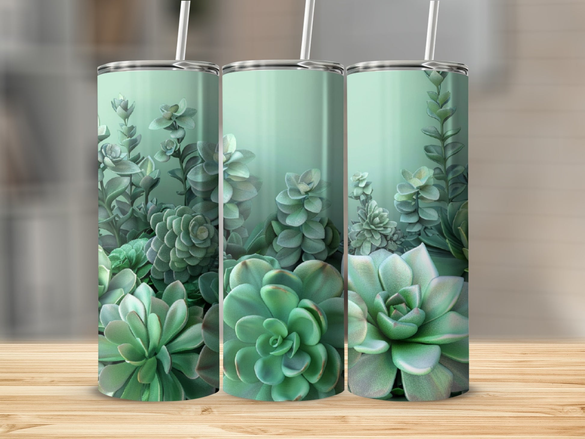 Three tumblers with a succulent plant design, arranged on a wooden surface.