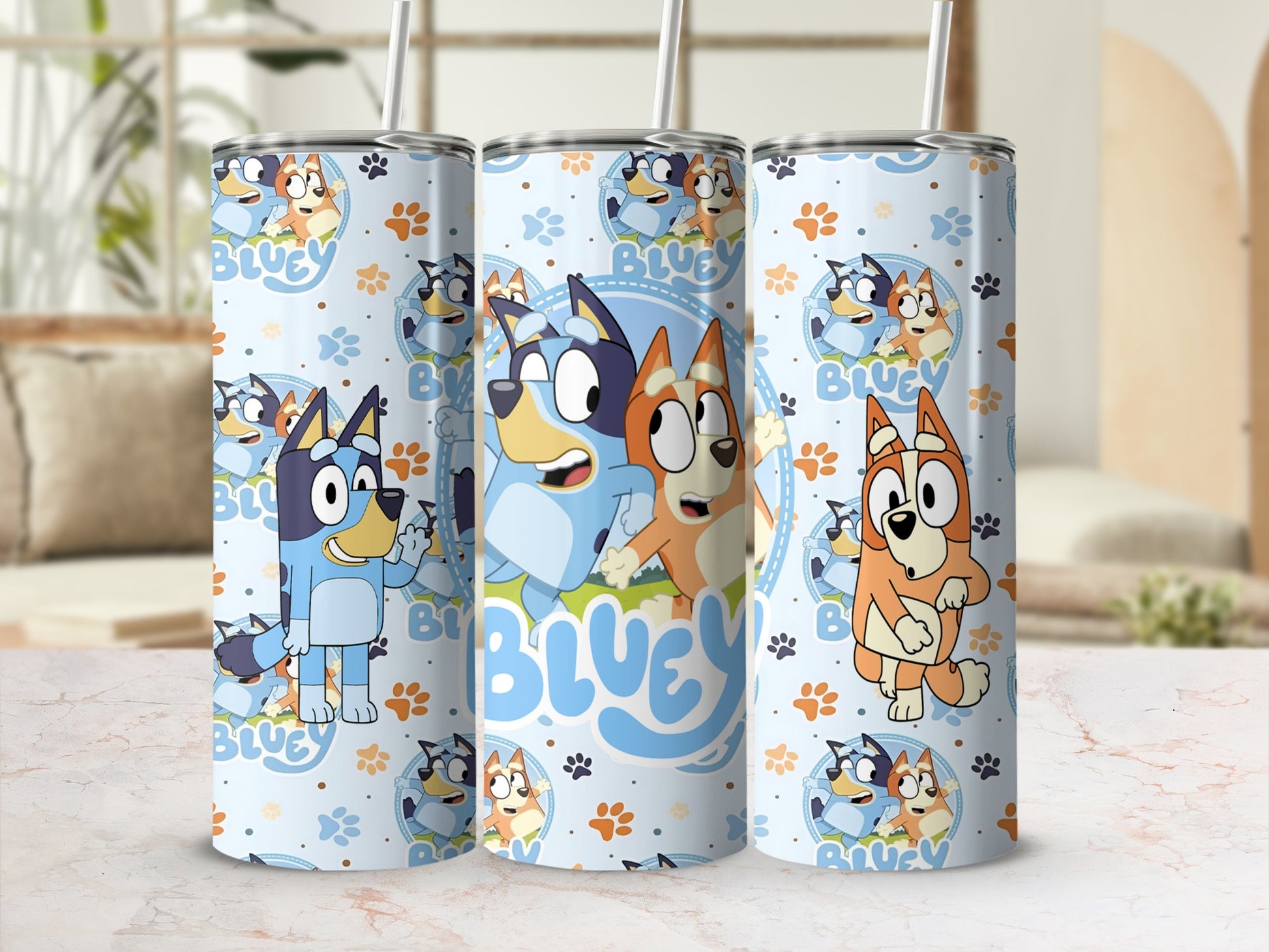 Bluey and Bingo characters on a light blue patterned tumbler with straw.