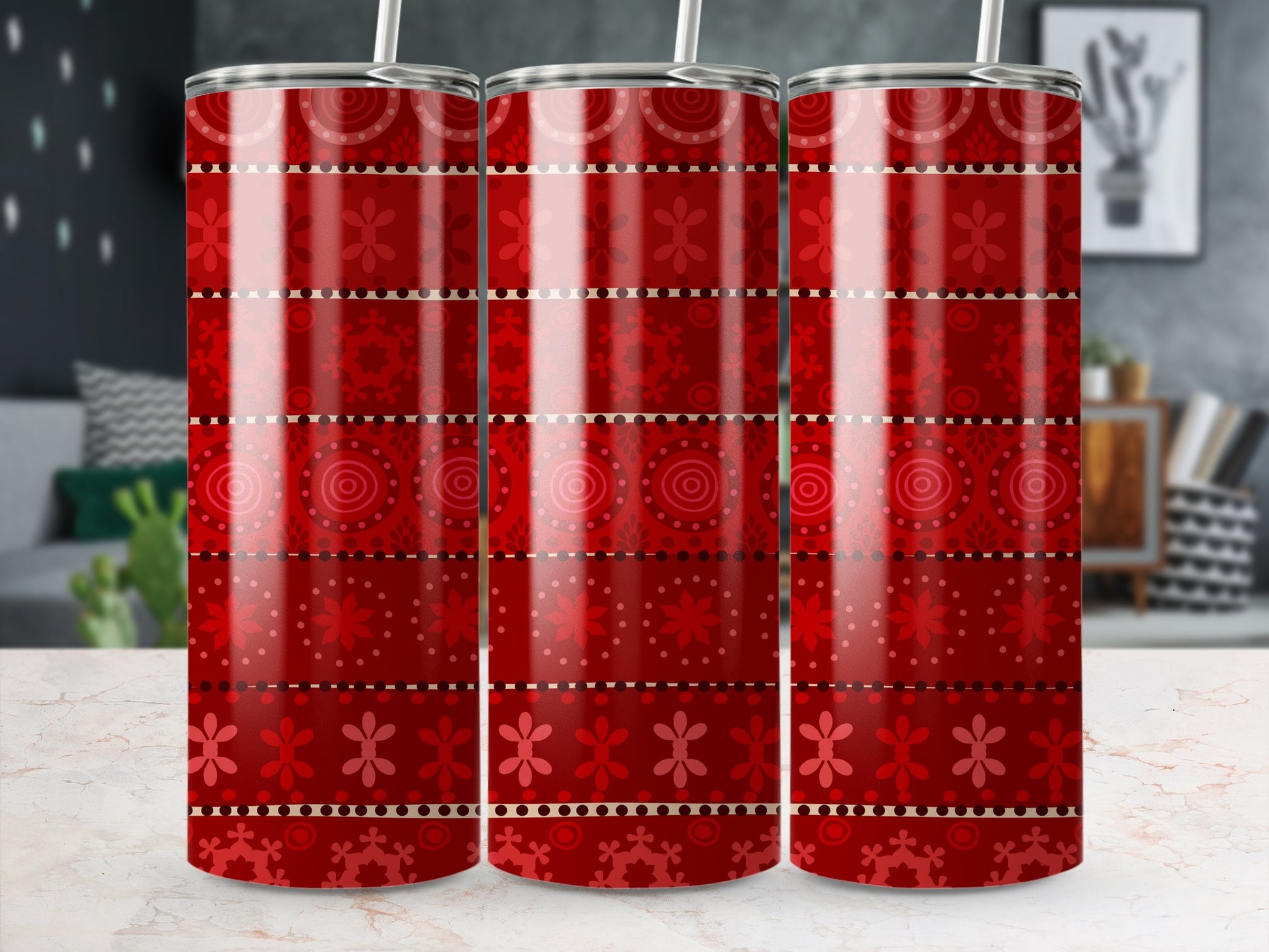 Three red tumblers with a patterned design of circles and flowers.