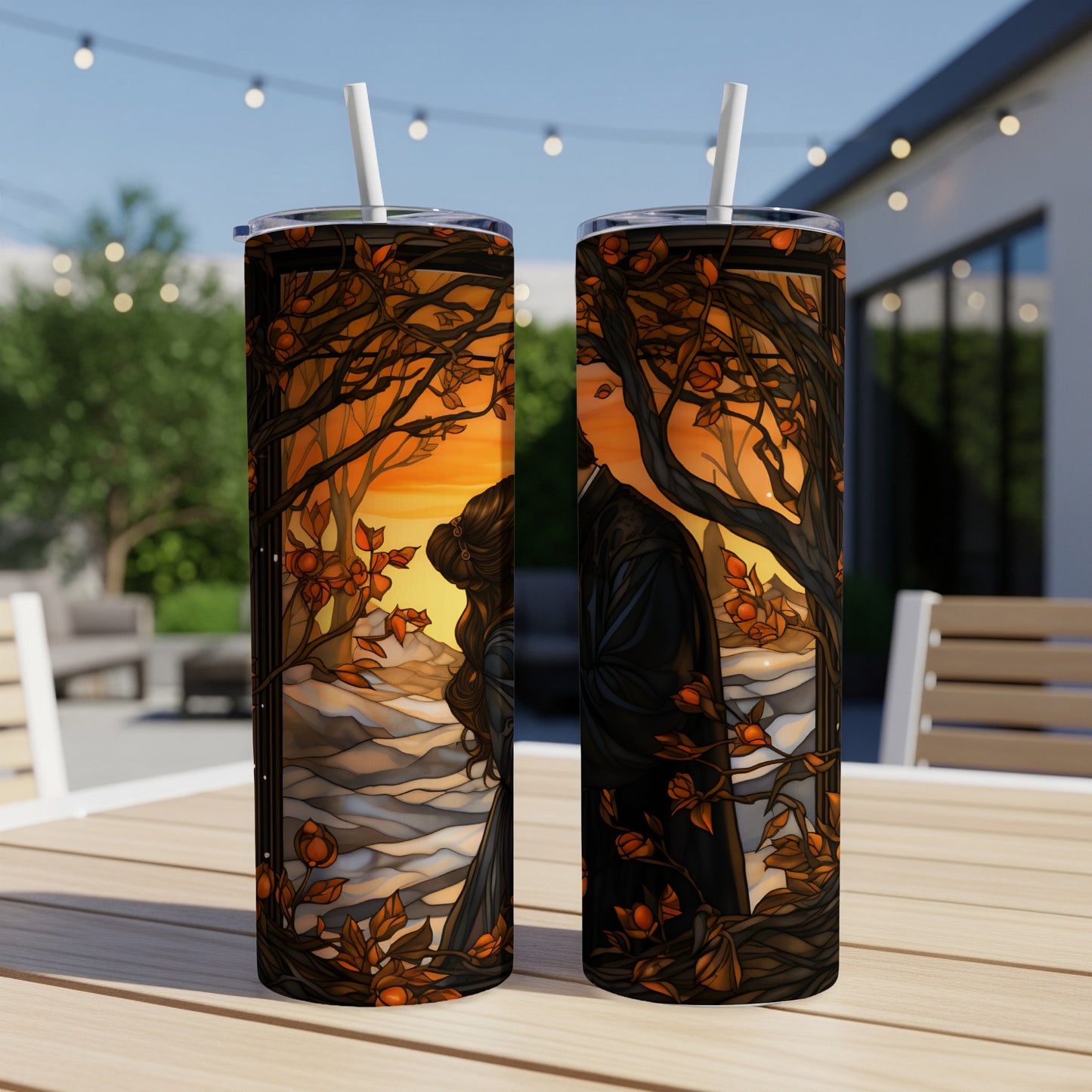 Couple embracing amidst autumn trees at sunset, artwork on two tumblers.