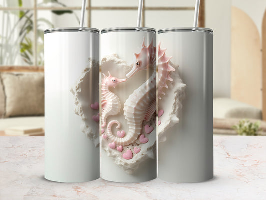 Three white tumblers with pink seahorses and heart details.