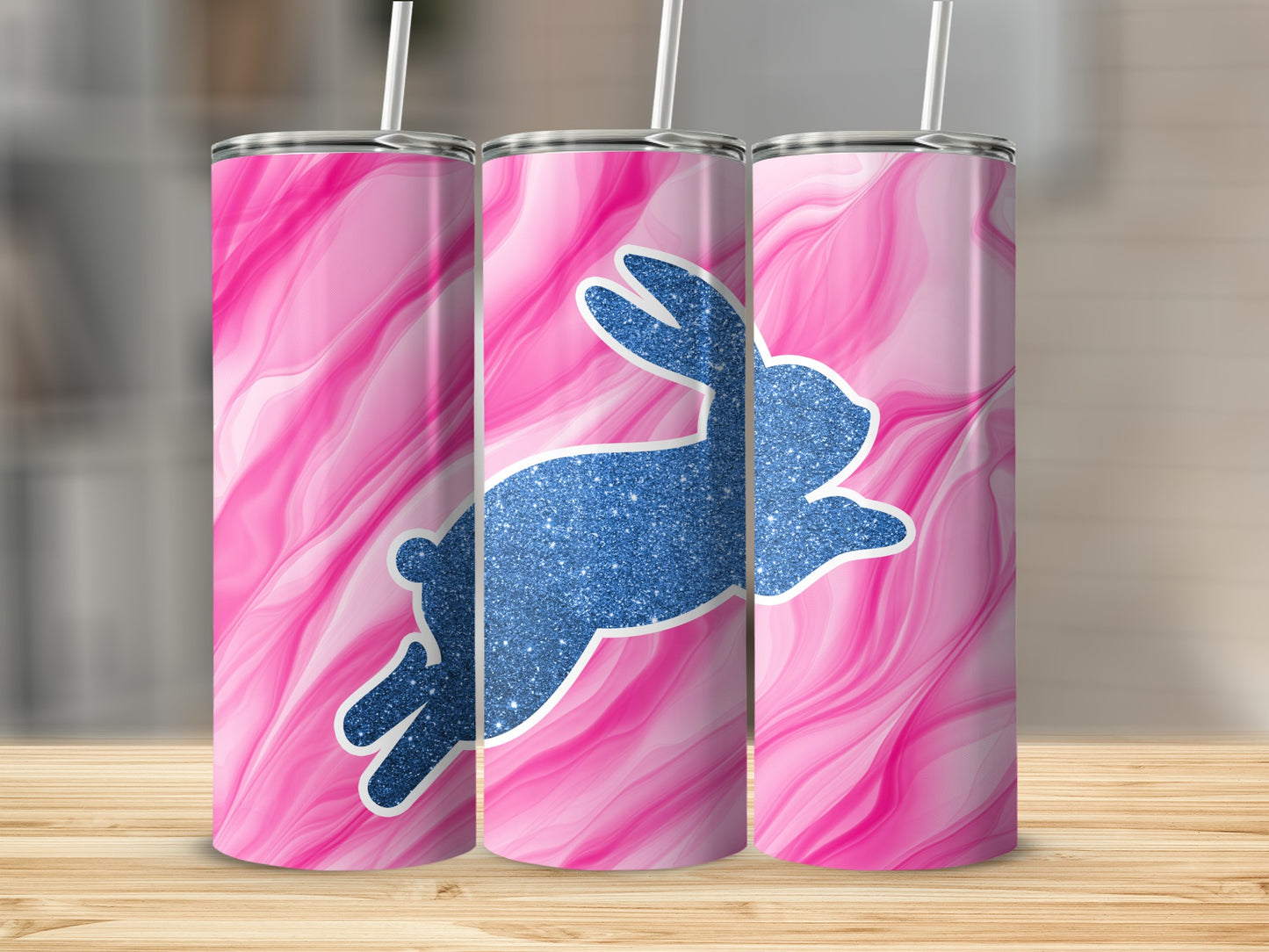 Three pink marble-patterned tumblers with a sparkly blue bunny silhouette.