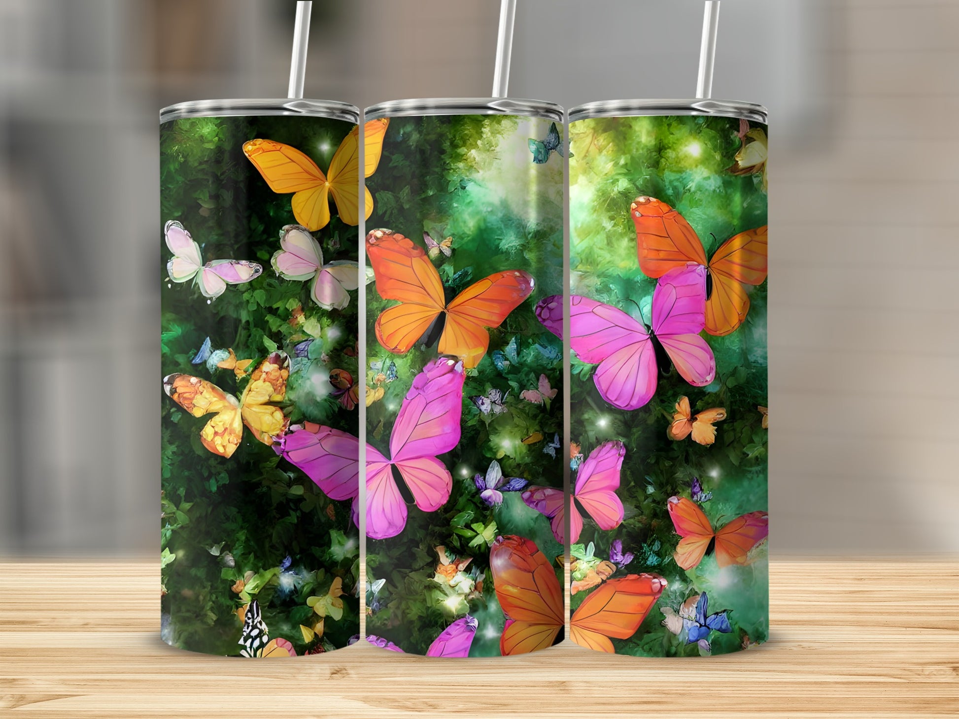 Three tumblers with colorful butterflies and green foliage design.