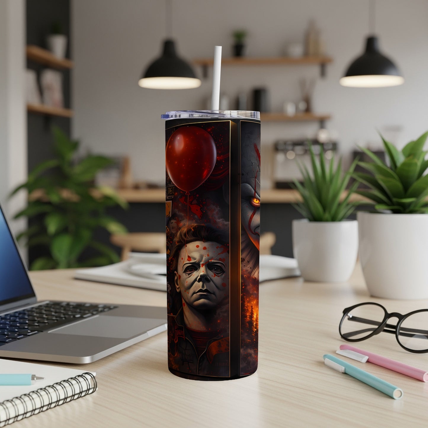 Tumbler featuring Michael Myers, Pennywise, and a red balloon on a dark, fiery background.
