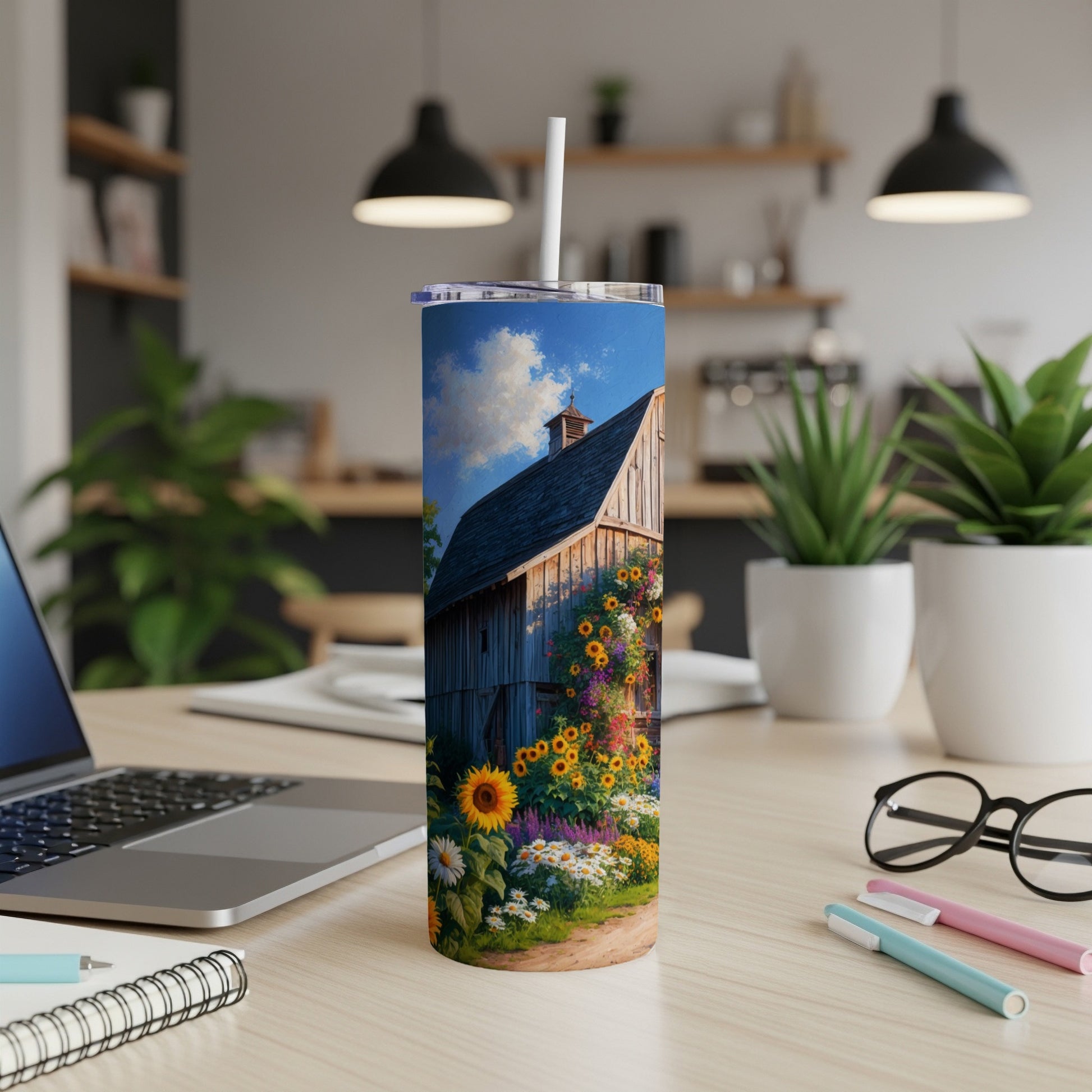 Barn with sunflowers and daisies in a rural setting on a tumbler.