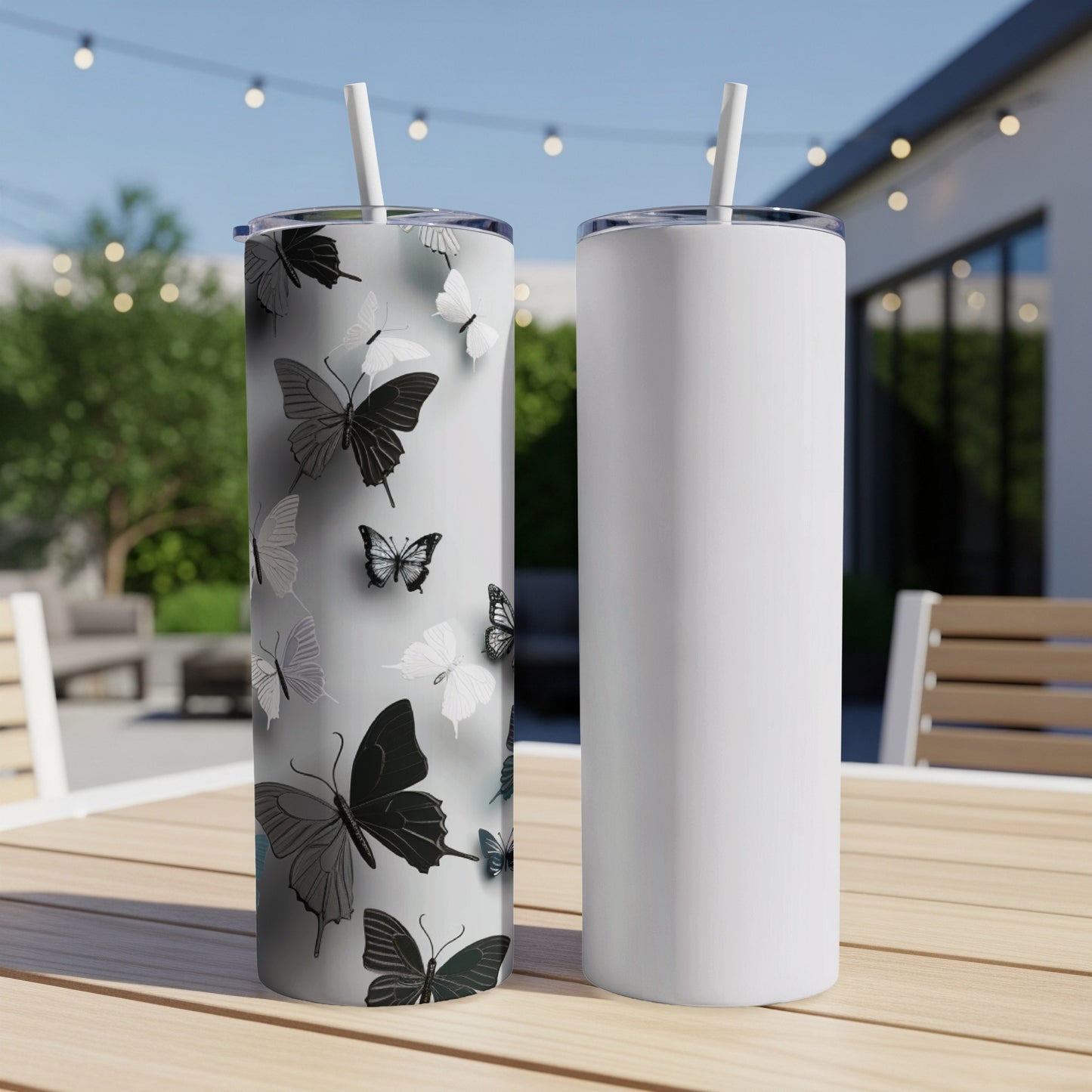 Two tumblers with grayscale butterfly pattern and a plain white tumbler.