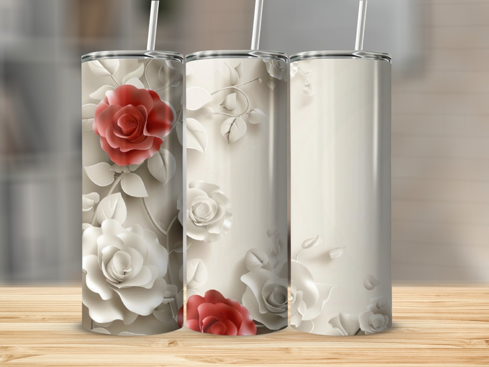 Three tall, skinny tumblers featuring embossed cream and red roses.