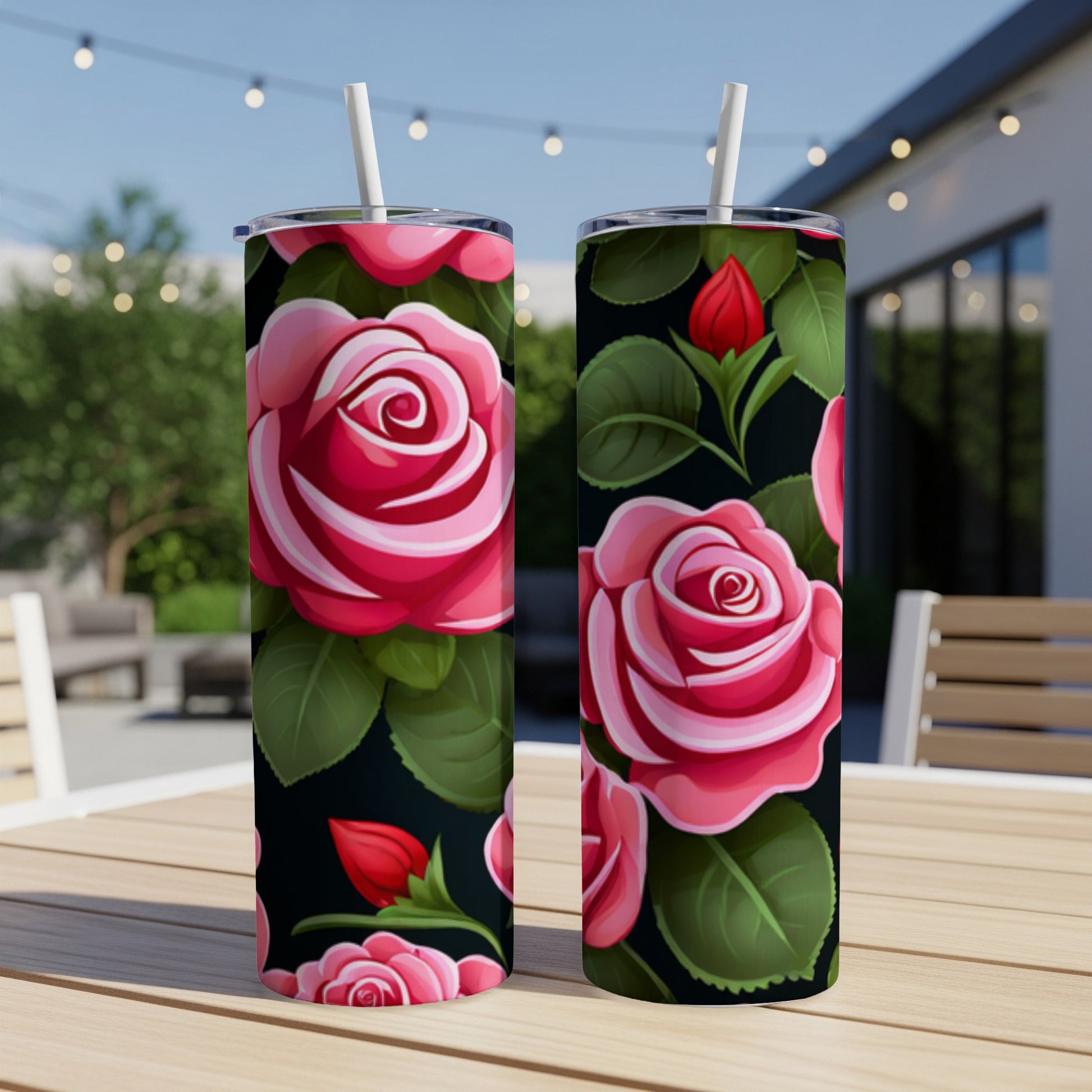 Two pink roses on tumblers with a floral pattern on a wooden table.