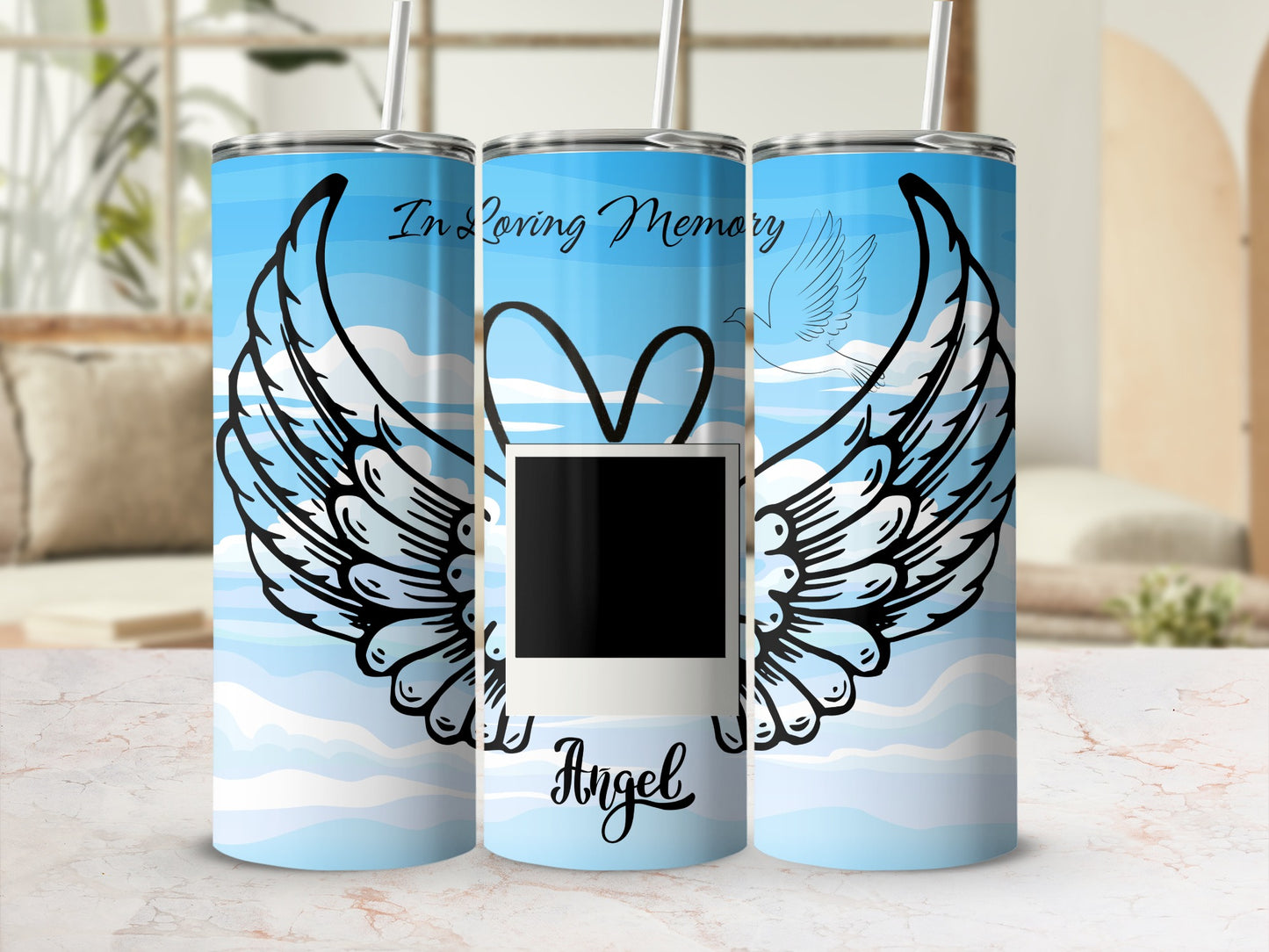Tumbler with "In Loving Memory" text, wings, dove, and "Angel" text on blue sky background.