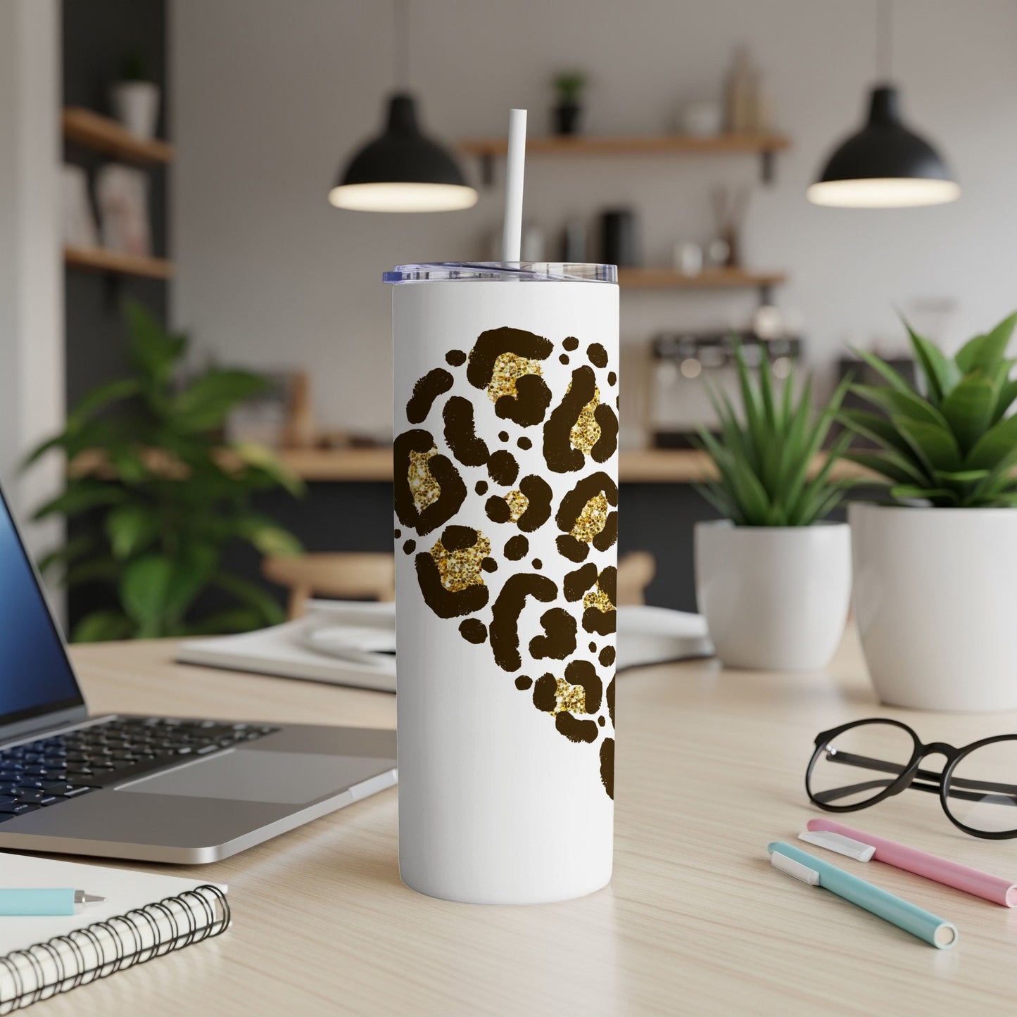 White tumbler with gold leopard print pattern and white straw.