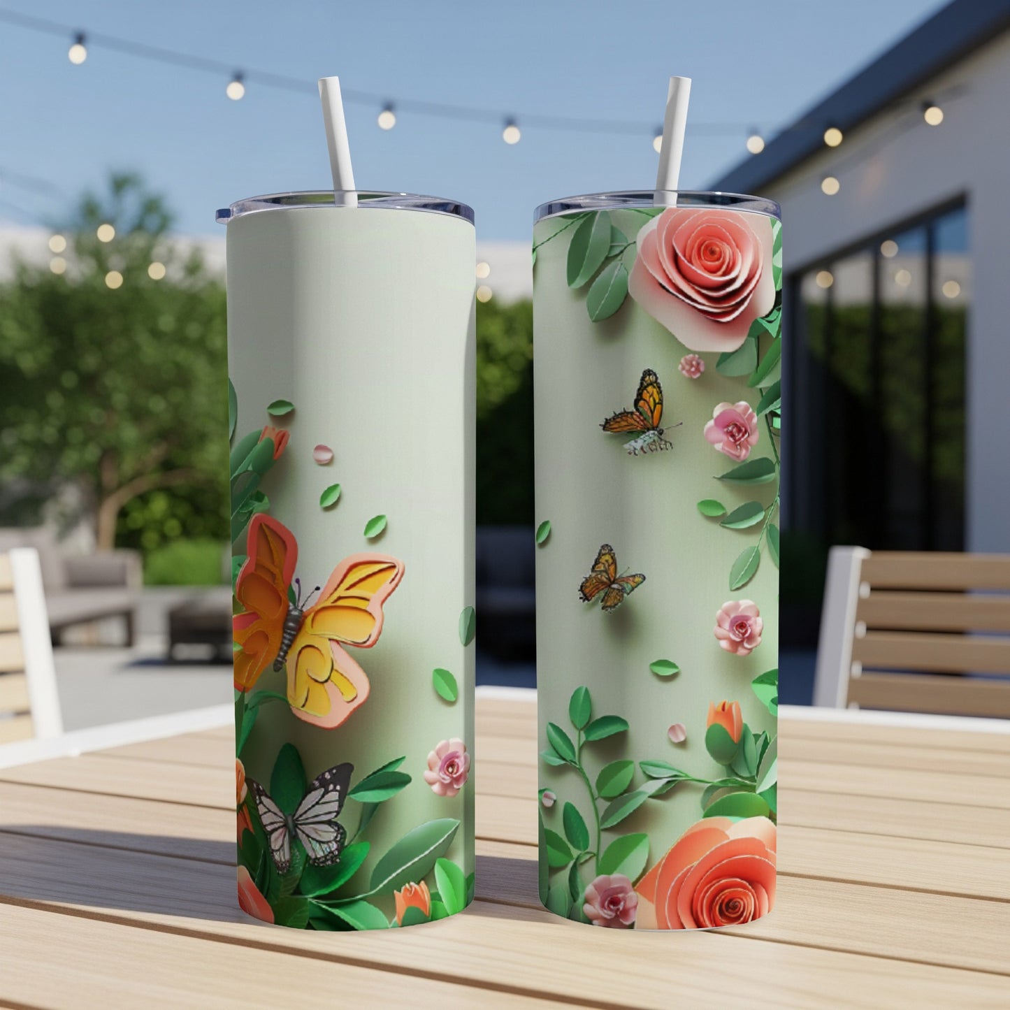 Two tall, skinny tumblers with butterflies and roses design.