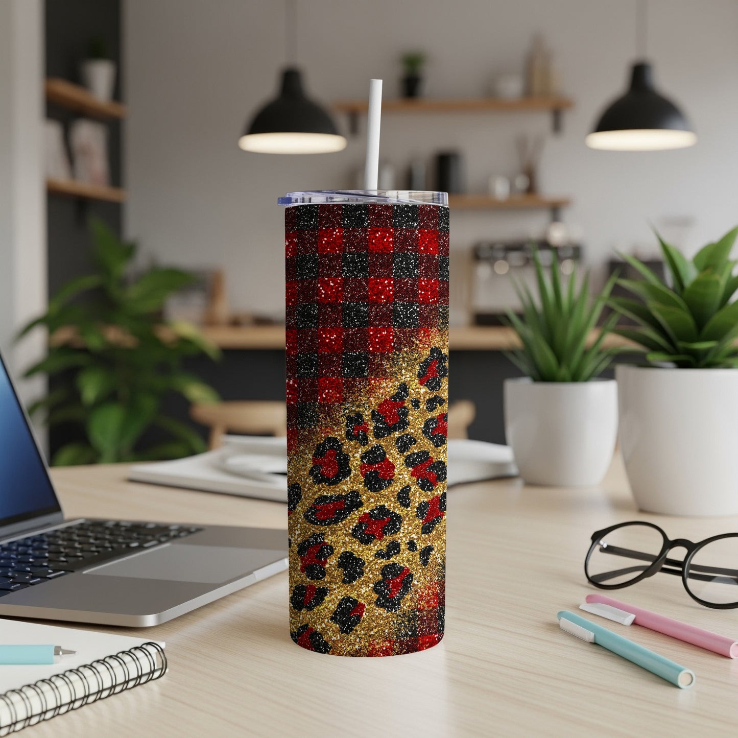 Red and black plaid tumbler with gold leopard print overlay and straw.