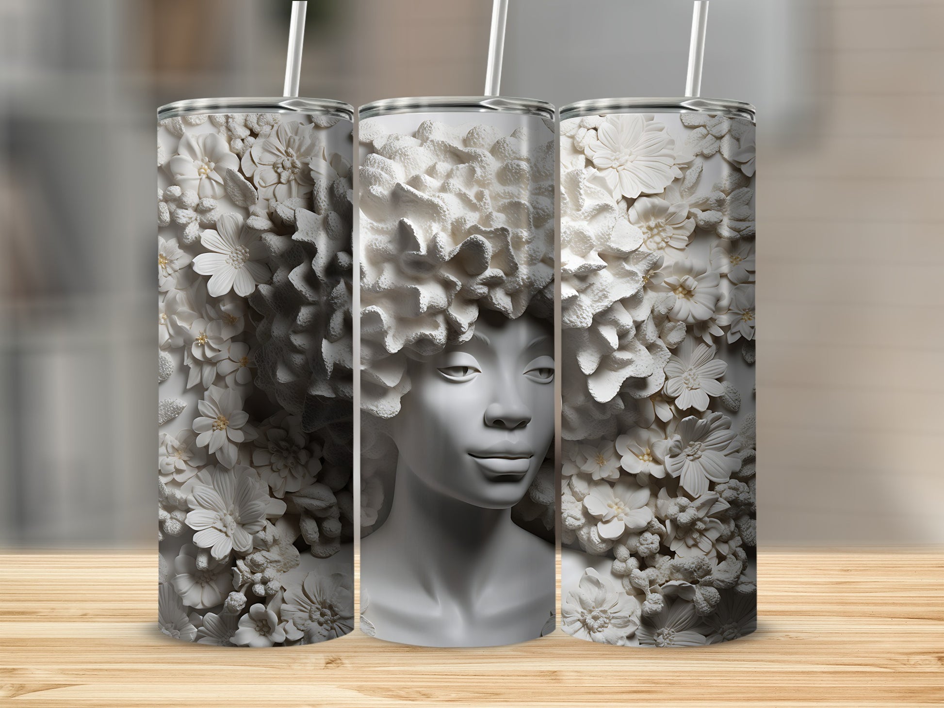 Three white tumblers with raised floral patterns and a woman's face.