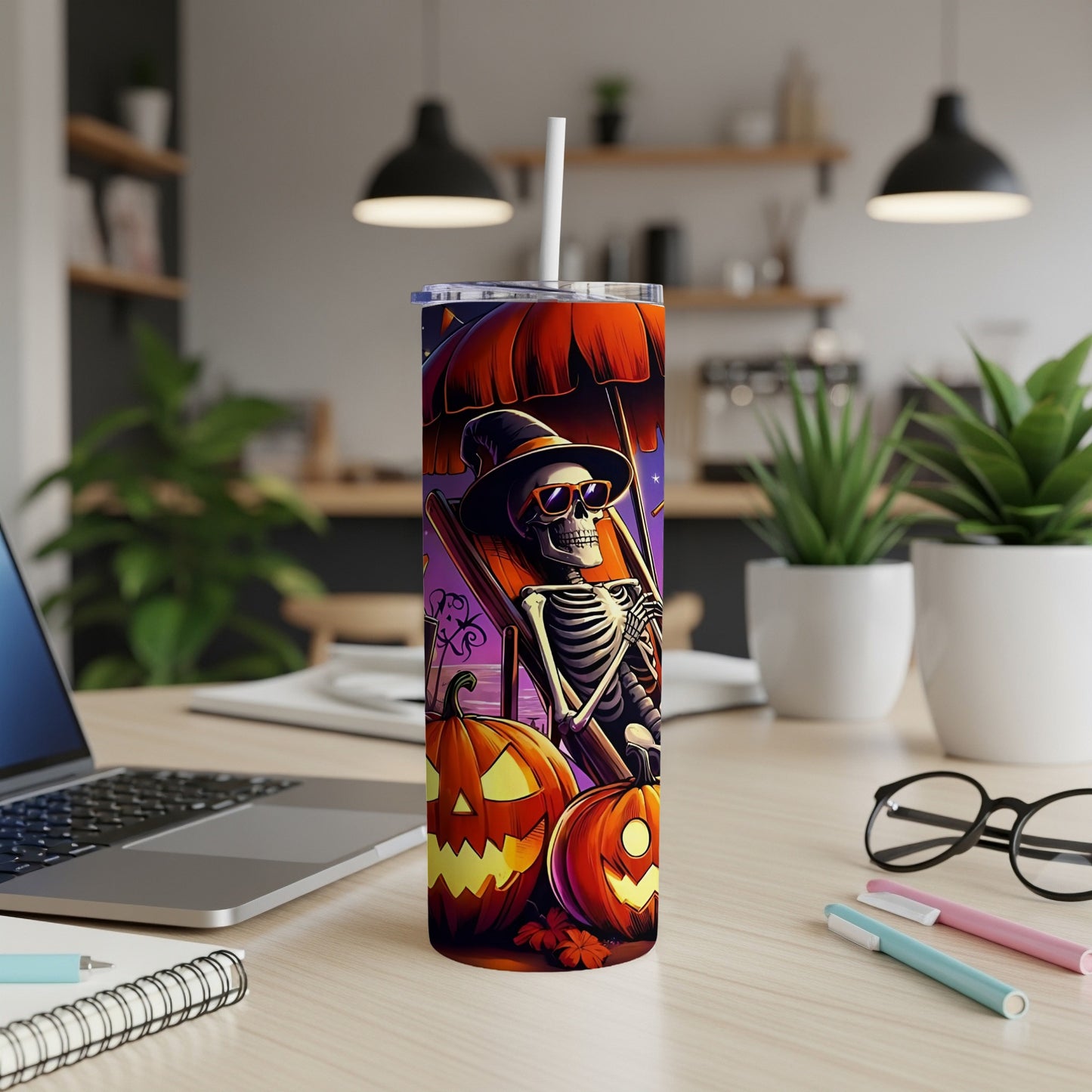 Skeleton relaxing under an umbrella with pumpkins, on a Halloween-themed tumbler.