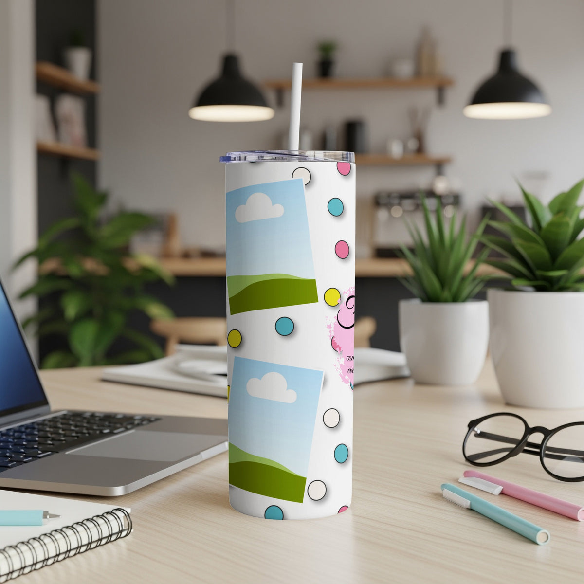 Tumbler with polka dots, framed photos, and pink cartoon character with text.