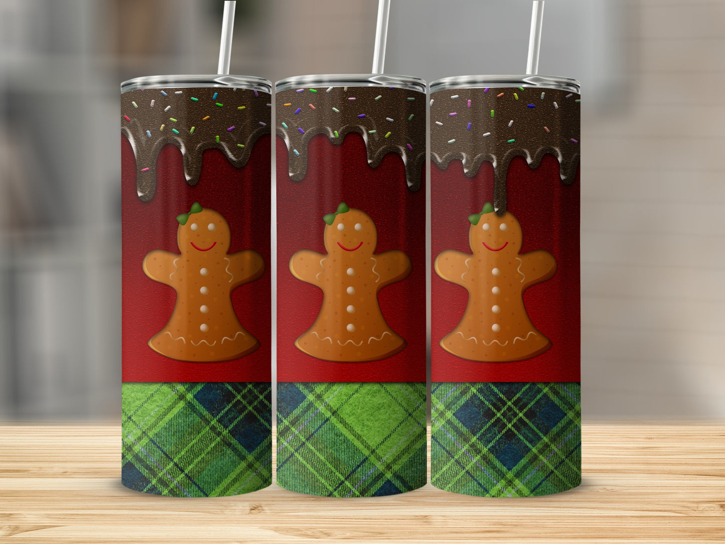 Three gingerbread men with chocolate and sprinkles on a red and plaid background.
