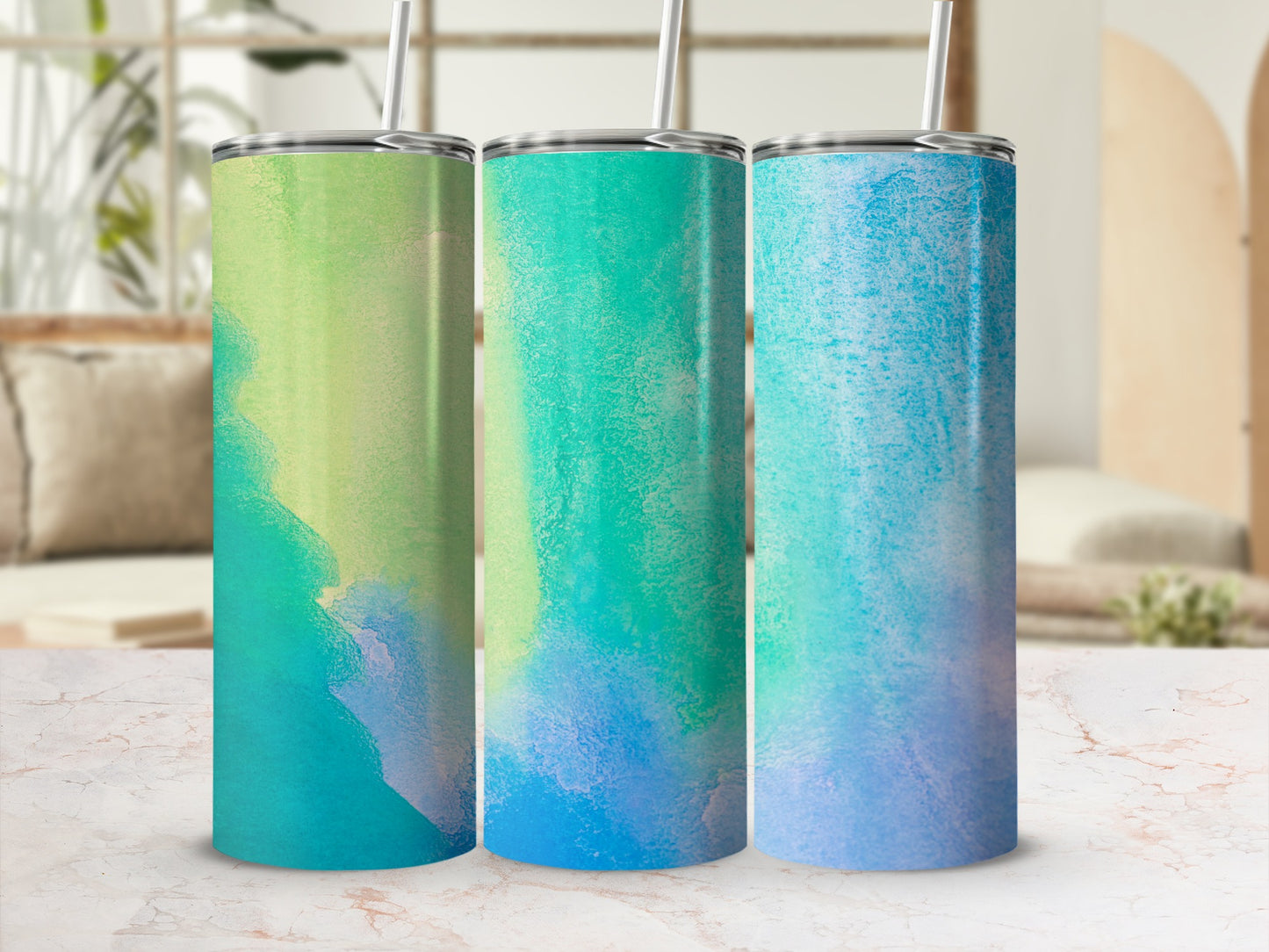 Three tumblers with green, blue, and teal watercolor designs.