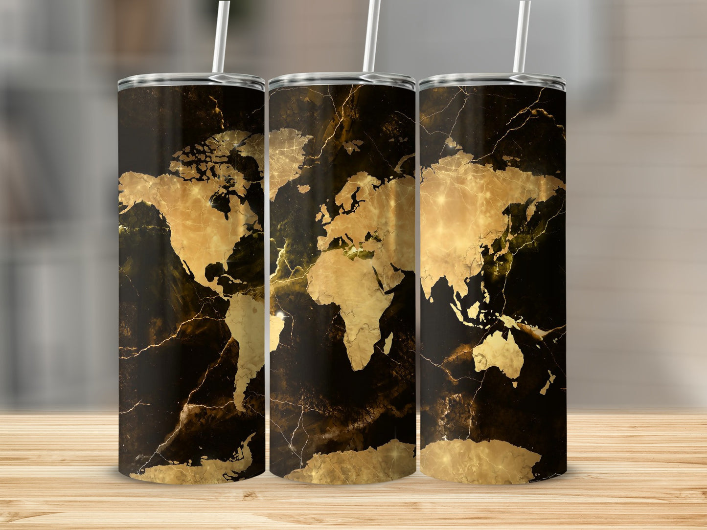 Three tumblers with a black marble background and gold world map design.