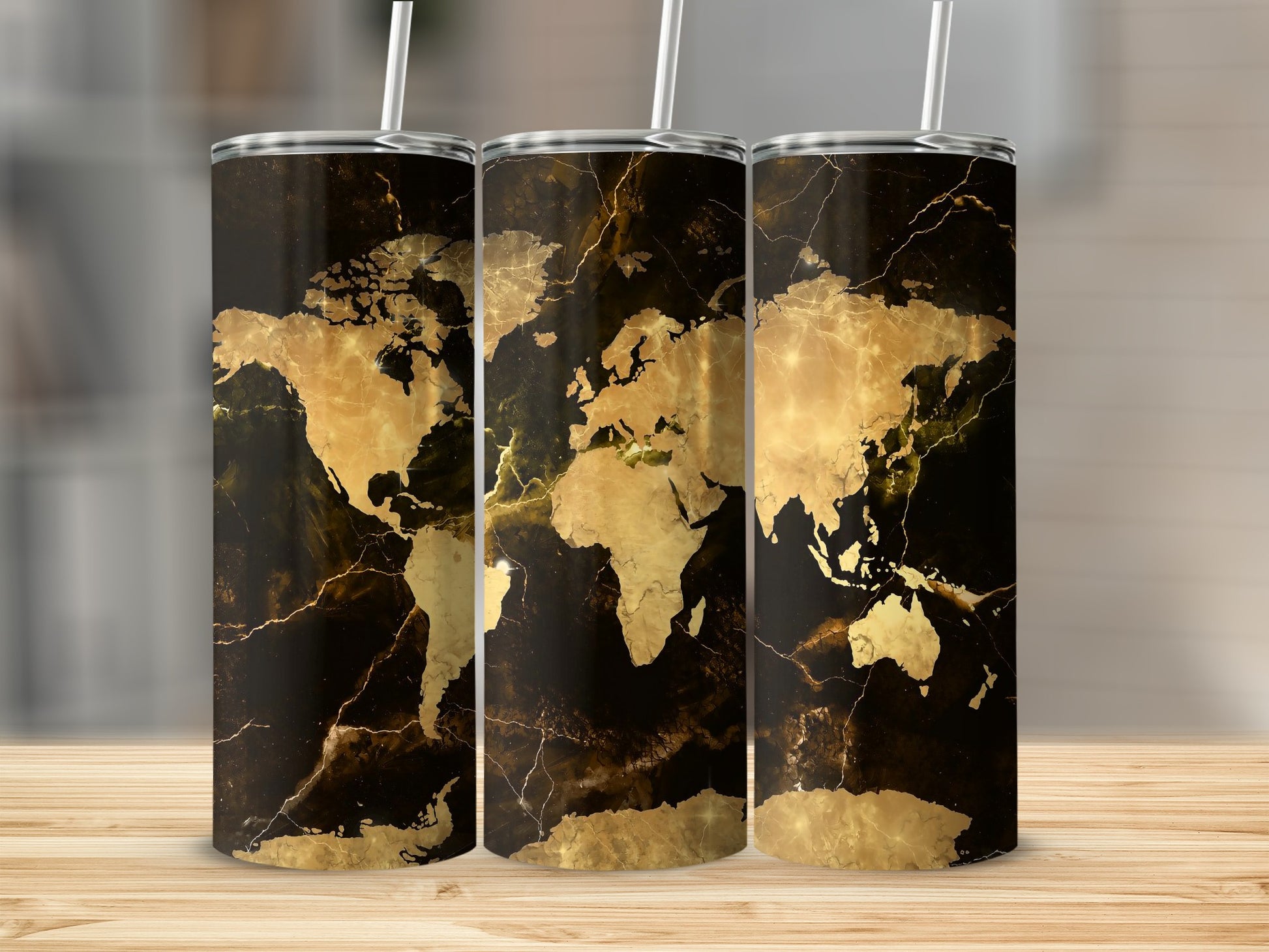 Three tumblers with a black marble background and gold world map design.