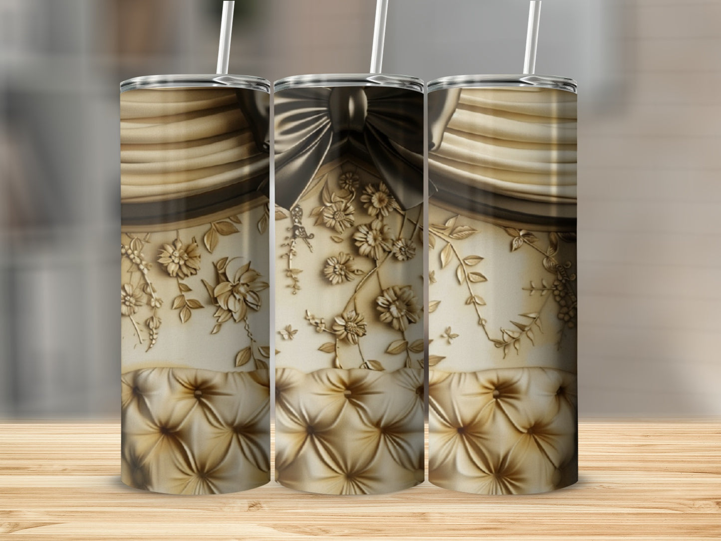 Three ornate tumblers with a tufted gold pattern and floral accents.
