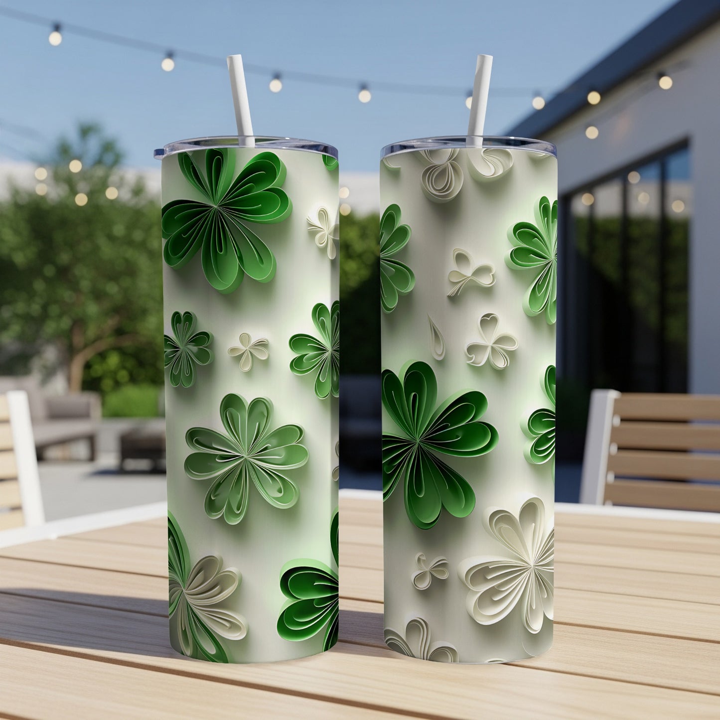 Two tumblers with green and white paper shamrock designs sit on a table.