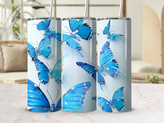 Blue butterflies on a white tumbler with straws and straw lids.