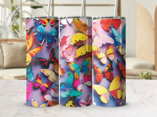Three tumblers with colorful butterfly patterns on a light background.