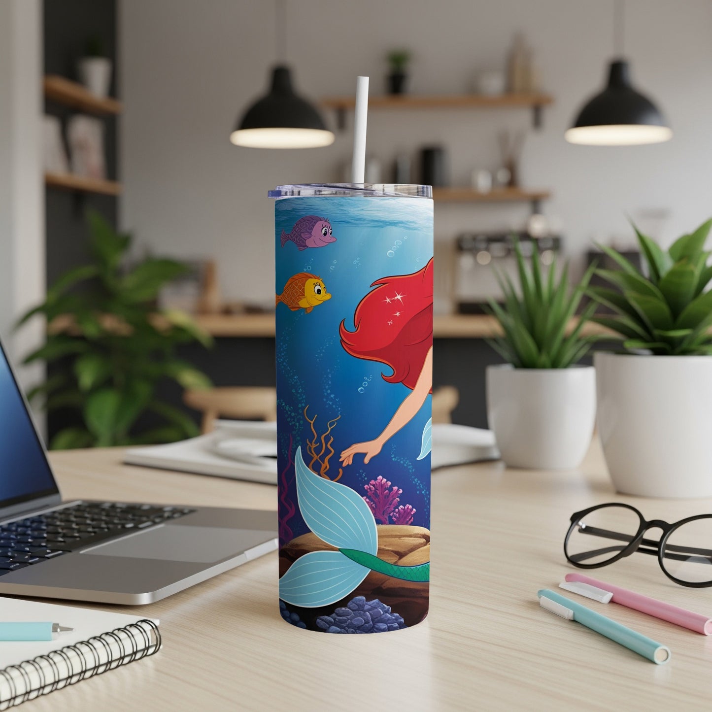 Ariel the mermaid with fish and coral underwater on a white tumbler.