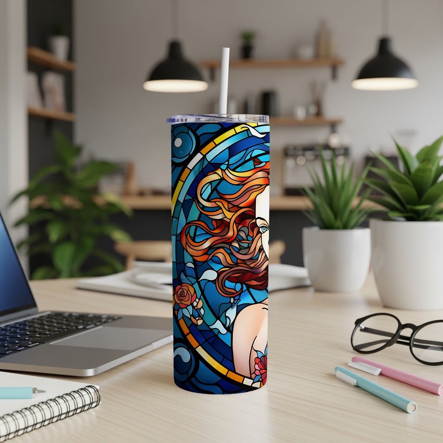 Colorful stained glass design of a woman's face and a rose on a tumbler.