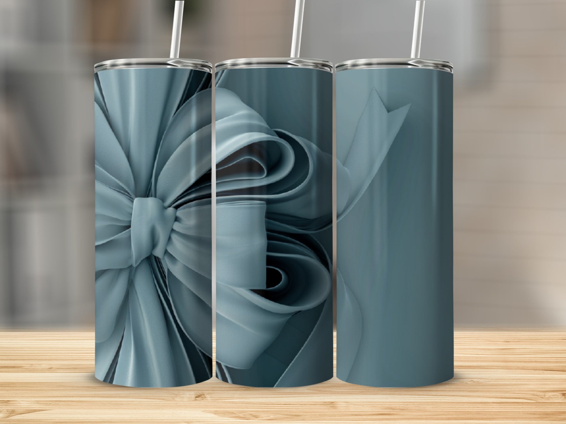 Three blue gift ribbon tumblers on a wooden surface.