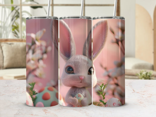 Three tumblers with a cartoon bunny holding an Easter egg, on a marble surface.