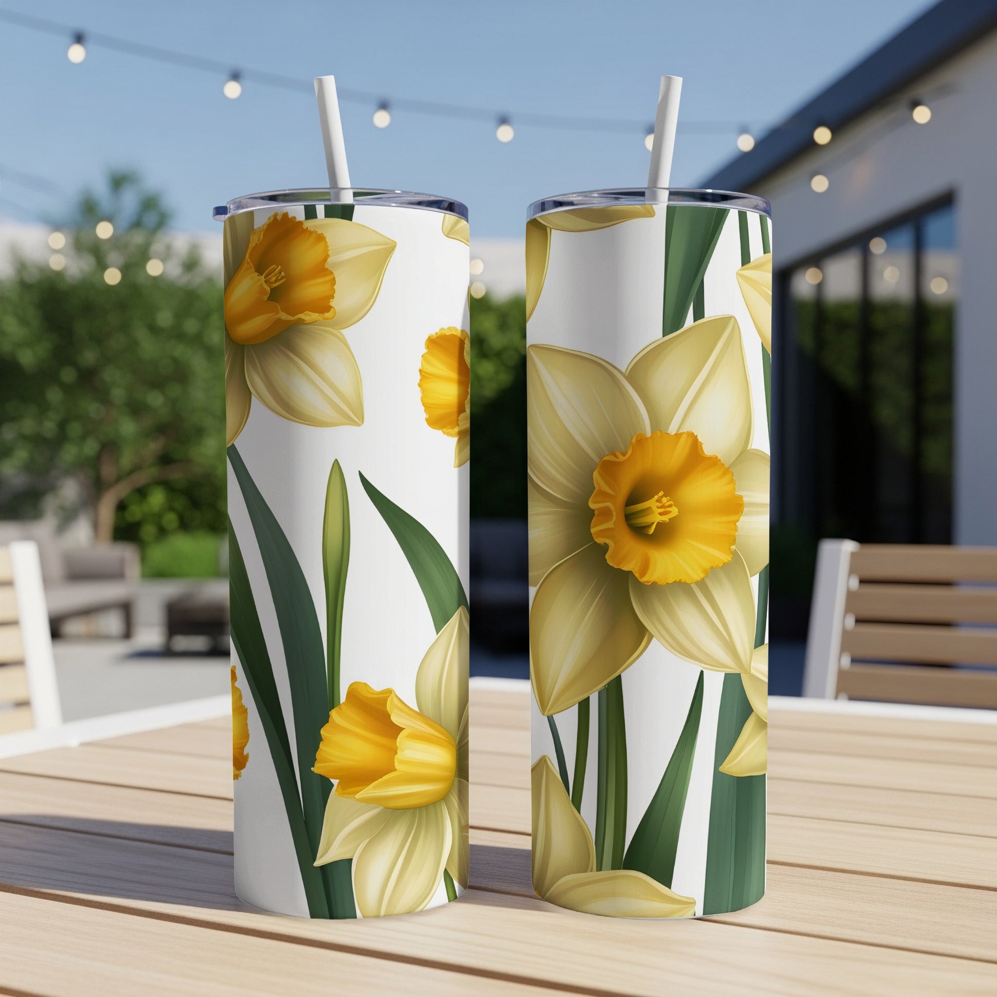 Two white tumblers with a yellow daffodil floral pattern.