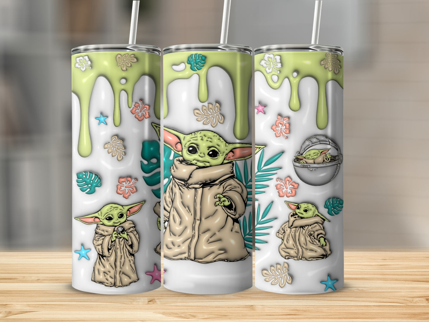 Grogu in a coat, with flowers and stars, on three tumblers.
