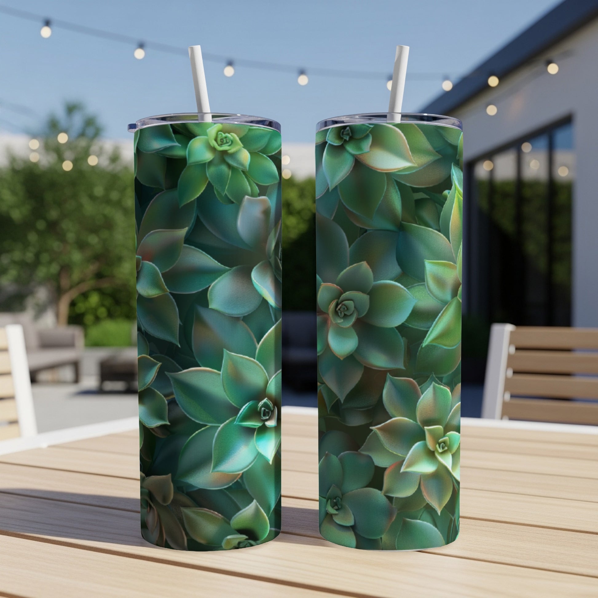 Two tumblers with succulent plant pattern on a table outdoors.
