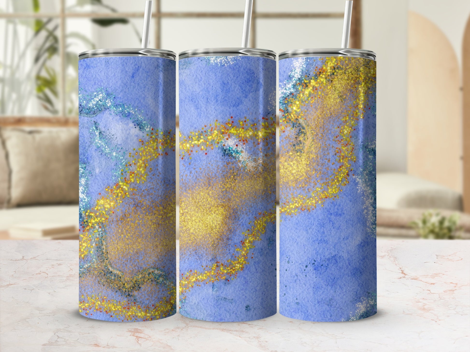 Three tumblers with blue watercolor and gold glitter design.