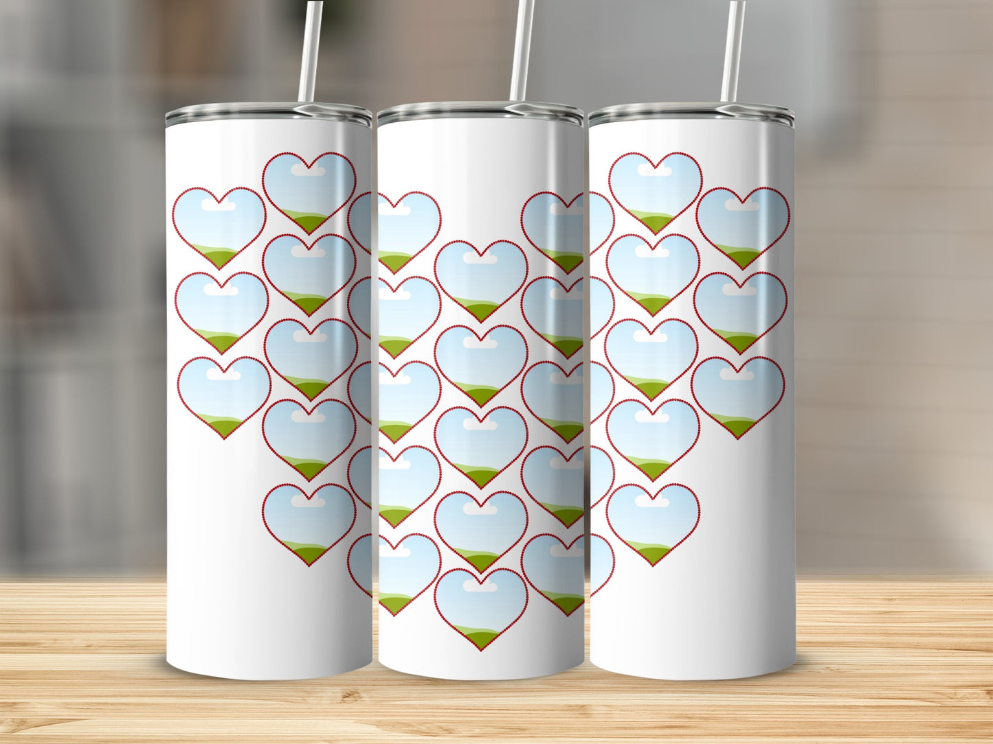 Three white tumblers with a heart pattern featuring a landscape inside each heart.