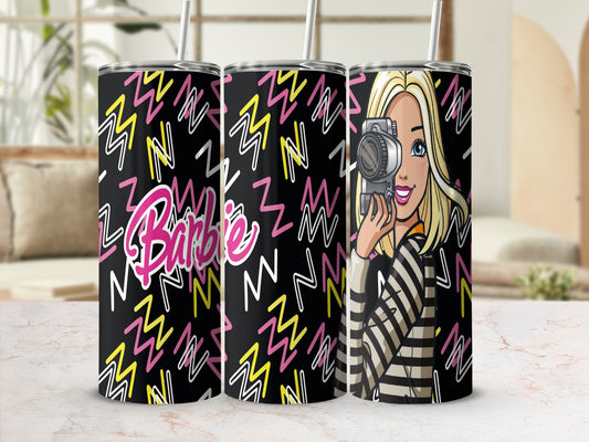 Barbie tumbler with pink and yellow zigzags and a camera-holding Barbie graphic.